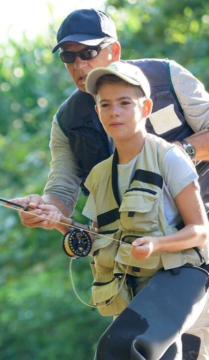 Father teaching son to fly fish Father teaching son to fly fish